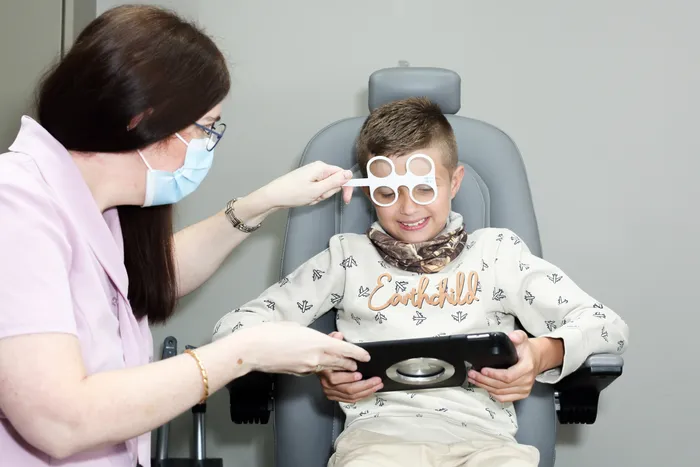 An optometrist using Eyeli's iPad-based testing during a patient exam